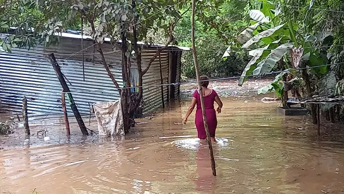 Una de las damnificadas observa como su casa fue inundada y perdió parte de sus pertenencias.